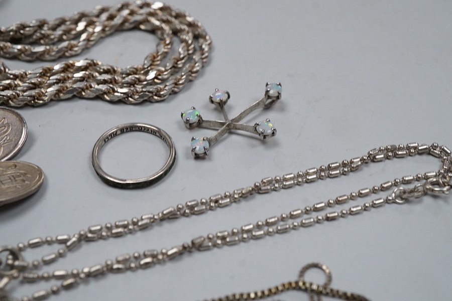 A collection of silver jewels, comprising: a bangle; a chain necklace suspending two winding toothpicks, one with toothpick deficient; a rope twist chain; a pair of cufflinks with the initials DBH; a pendant of abstract